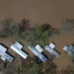 Kentucky watches for surging rivers to recede so widespread cleanup can begin