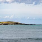 Early Hawaiian petroglyphs on a beach are visible again with changing tides