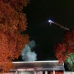 Suspect arrested after car crashes into post office and catches fire
