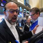 US futures slip and Asian stocks are mixed, while oil prices surge more than $1 a barrel