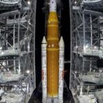 NASA hauls repaired moon rocket from hangar back to the pad for an early April launch
