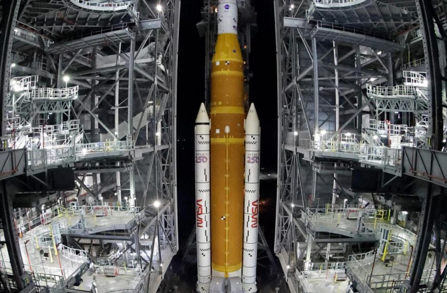 NASA hauls repaired moon rocket from hangar back to the pad for an early April launch