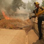 Fast-growing brush fire in Southern California threatens homes