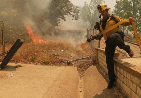 Fast-growing brush fire in Southern California threatens homes