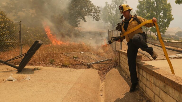 Fast-growing brush fire in Southern California threatens homes