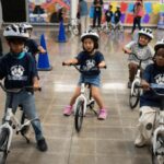 A childhood rite moves indoors as kindergartners learn to ride bikes in school gyms