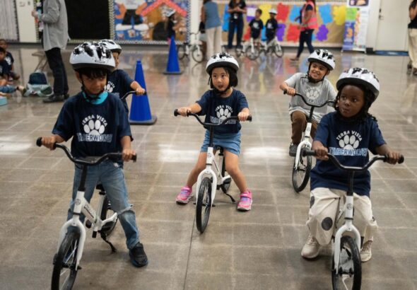 A childhood rite moves indoors as kindergartners learn to ride bikes in school gyms